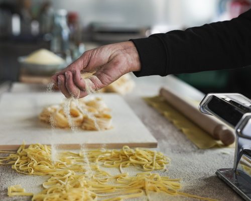 Woman working inside pasta factory - Fresh made taditional italian pasta